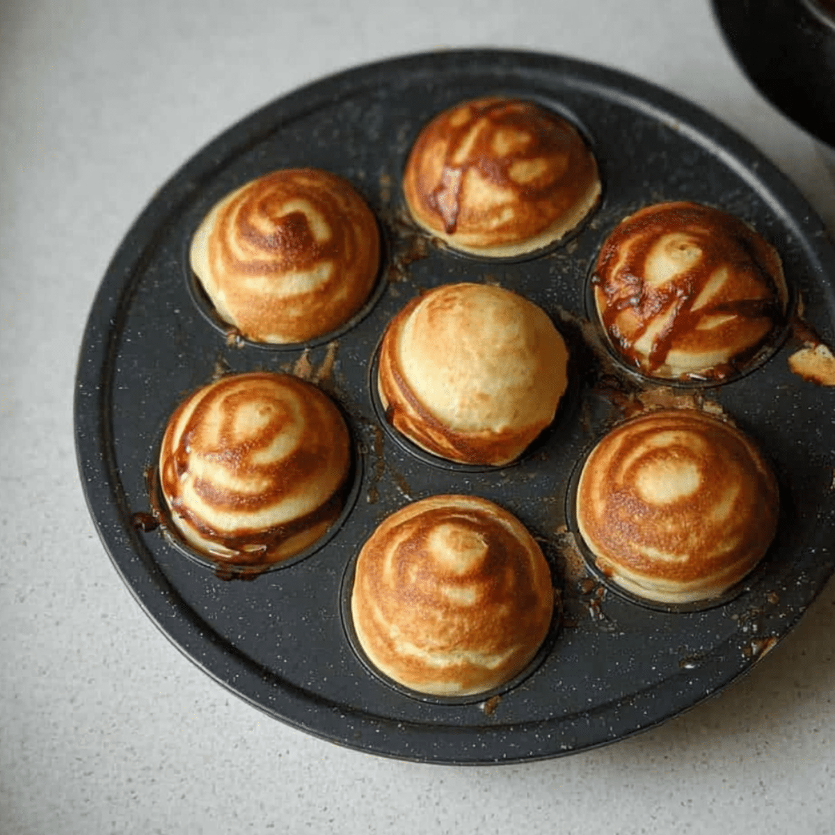 How to Make Fluffy Nutella Pancake Balls (With or Without a Special Pan!) 5 flipping Nutella pancake balls in Aebleskiver pan